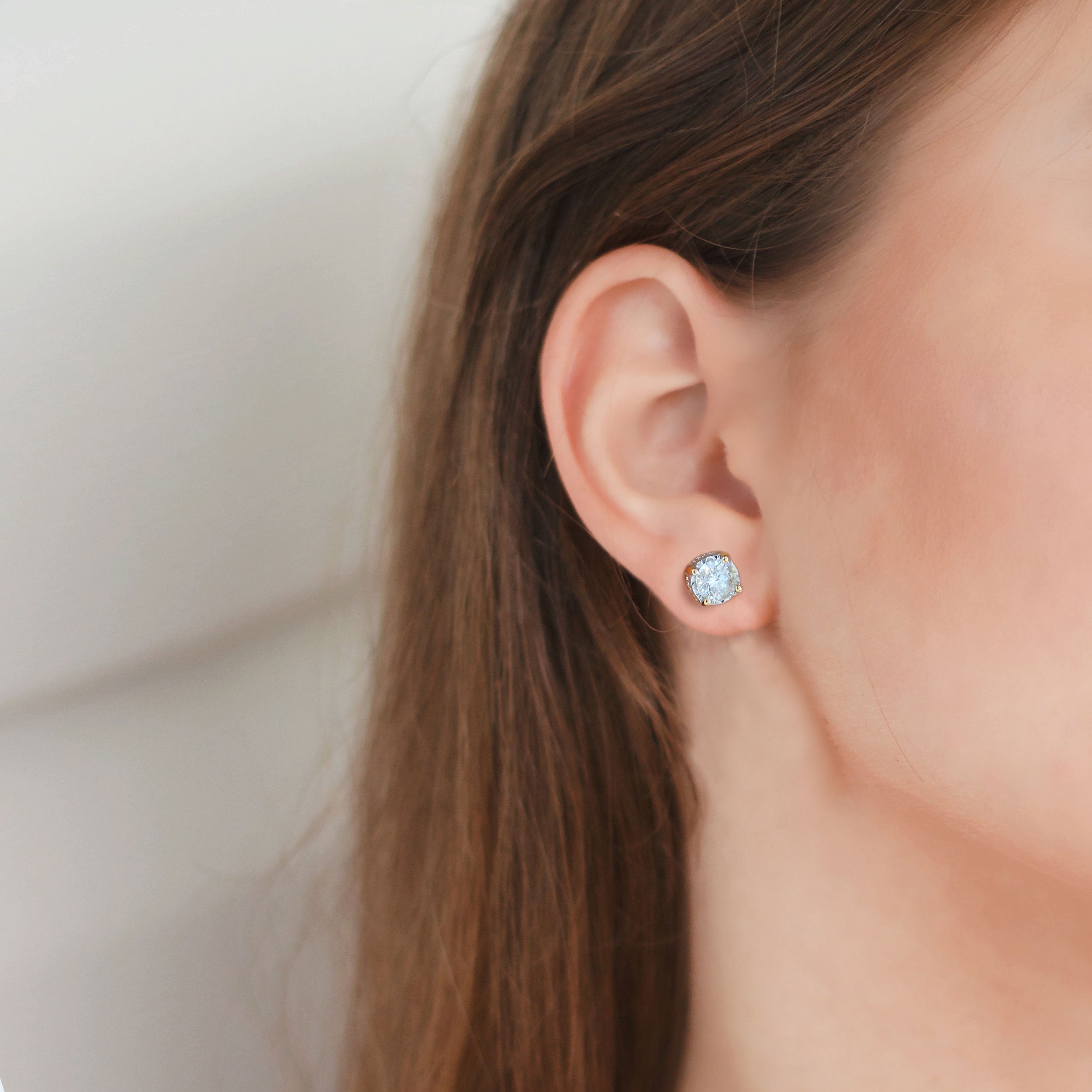 Closeup of a young woman's pierced ear with a silver ring with a small ball  – Girl with brown hair wearing a special earring Stock Photo | Adobe Stock