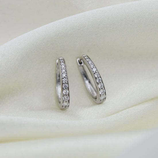 1/2 Cttw Diamond Channel Set Oval Hoop Earrings set in 925 Sterling Silver