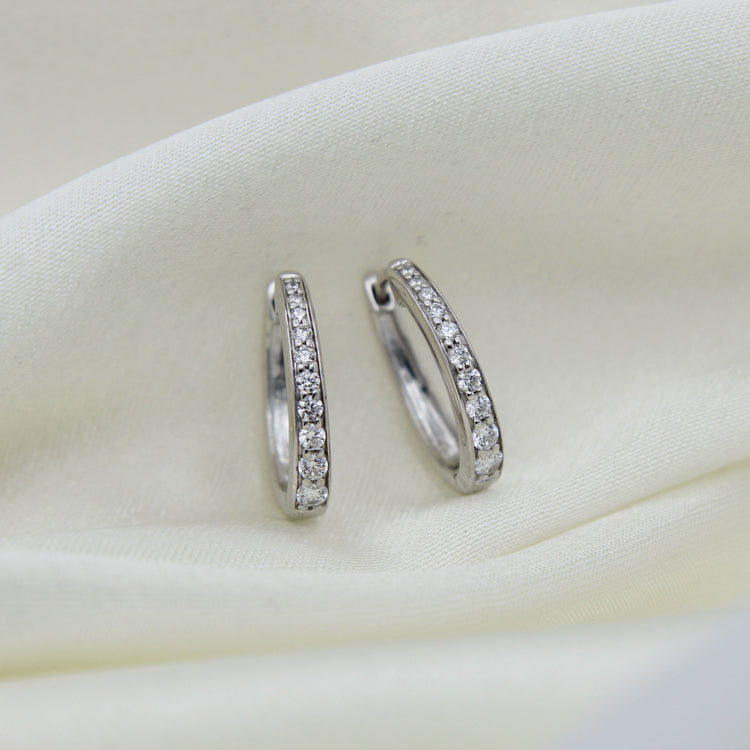 1/2 Cttw Diamond Channel Set Oval Hoop Earrings set in 925 Sterling Silver