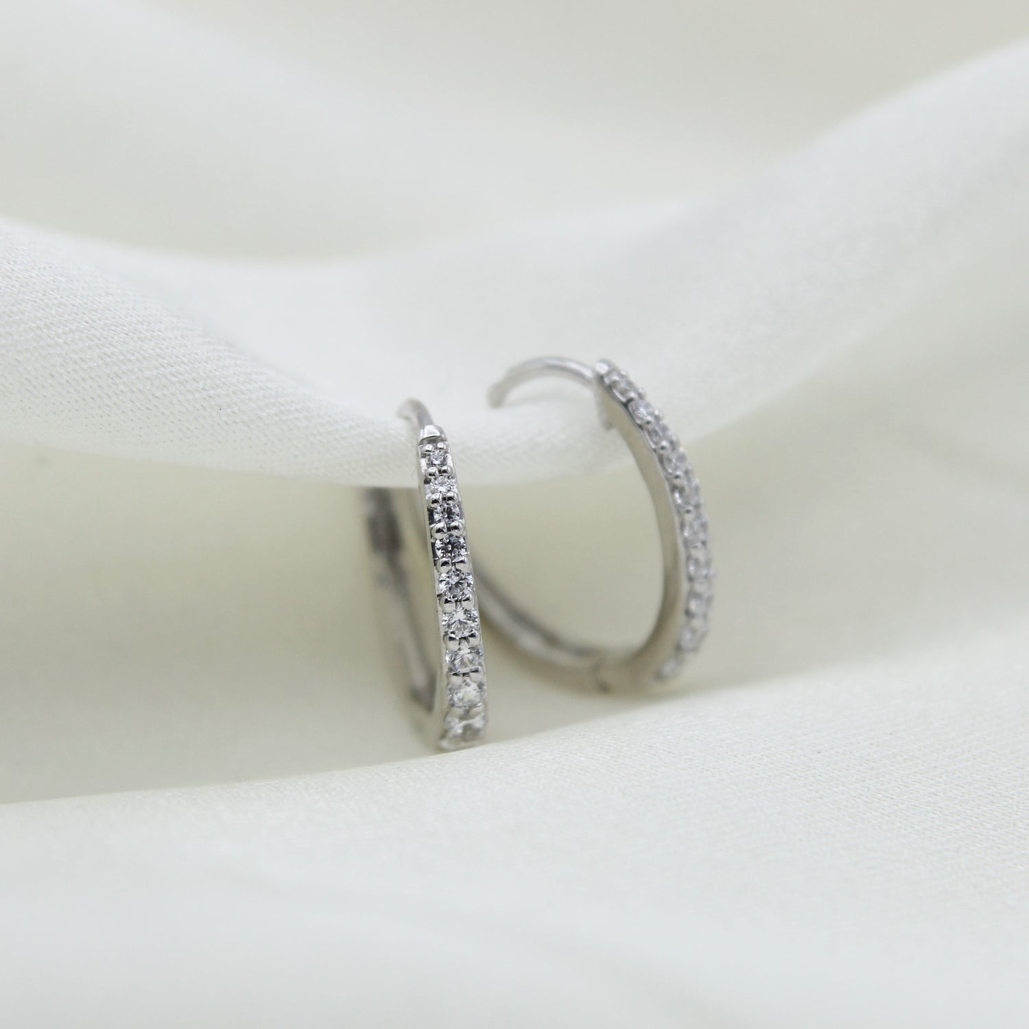 1/2 Cttw Diamond Oval Hoop Earrings set in 925 Sterling Silver